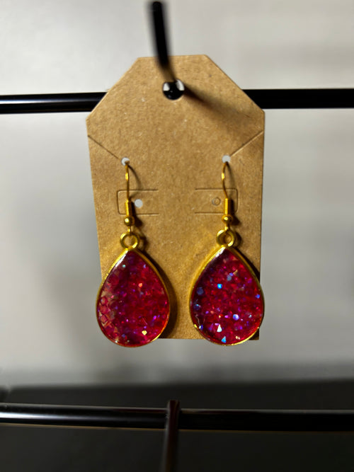Crimson iridescent glitter resin teardrop earrings in gold bezel setting on kraft card display