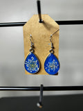 Queen Anne's lace pressed flower cobalt blue resin teardrop earrings with silver bezel on kraft card display